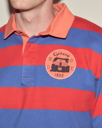 Person wearing the Clubhouse Rugby Shirt, a 100% cotton polo with wide red and blue stripes and a 