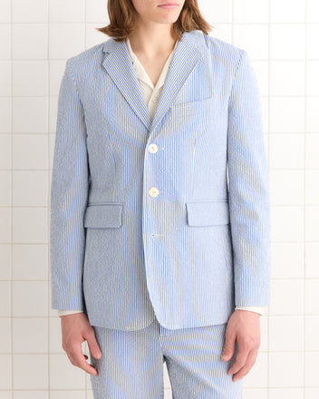 A person wears the Club Stripe Single-Breasted Suit Jacket in blue and white, set against a tiled white background.