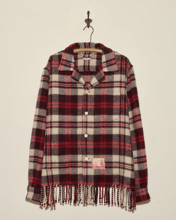 Collegiate Buffalo Overshirt - XXL: Red, black, and white plaid button-up with fringe at the bottom, made in New York by Brownsville Woolen Mills, hanging on a wall hook.