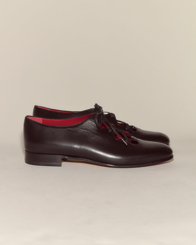 A pair of County Clare Shoes - Black, made in Italy from black Napa leather with red interior lining and laces, shown side by side.