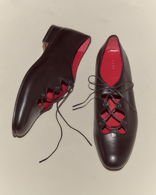 The County Clare Shoes - Black are crafted from black Napa leather with red interiors and a leather sole, showcased on a light background.