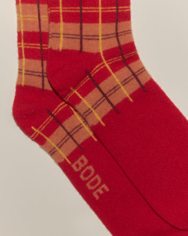 The County Plaid Socks - Red Multi feature a yellow and brown pattern, are crafted in Italy, and display "BODE" near the toe.