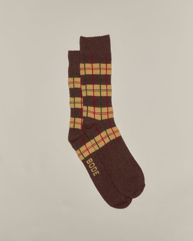 The County Plaid Socks - Multi feature a brown plaid design with yellow and red accents, made from soft merino cashmere for comfort. "BODE" is on one toe. Premium socks, made in Italy, shown on a neutral background.