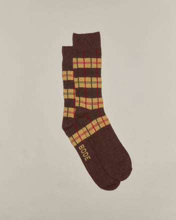 The County Plaid Socks - Multi feature a brown plaid design with yellow and red accents, made from soft merino cashmere for comfort. 
