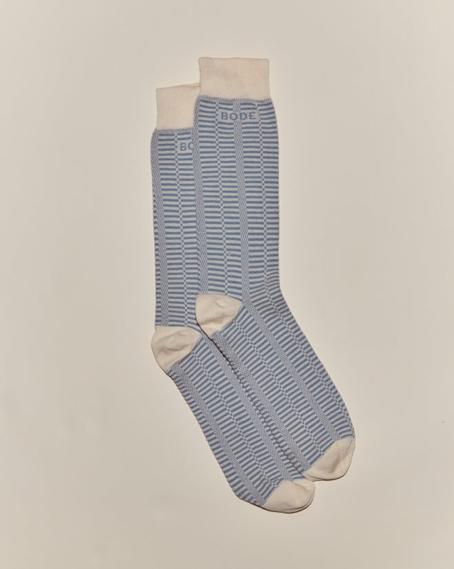 A pair of Micro Check Socks in blue and cream, featuring stripes and "BODE" text near the top, reminiscent of vintage children's socks, displayed on a plain background.