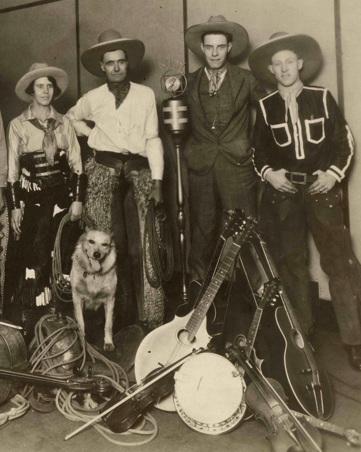 Historic photo of a band of country musicians dressed in western attire.