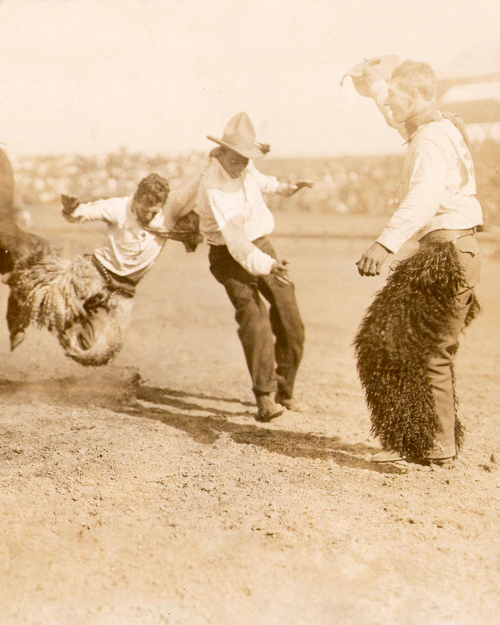 Historic photo of three male rodeo riders.