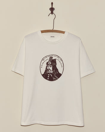 The Dracula Tee features a white T-shirt on a hanger with a black graphic of a man's face and circular text above him—perfect for vintage or Dracula shirt collectors and Halloween Tees enthusiasts.