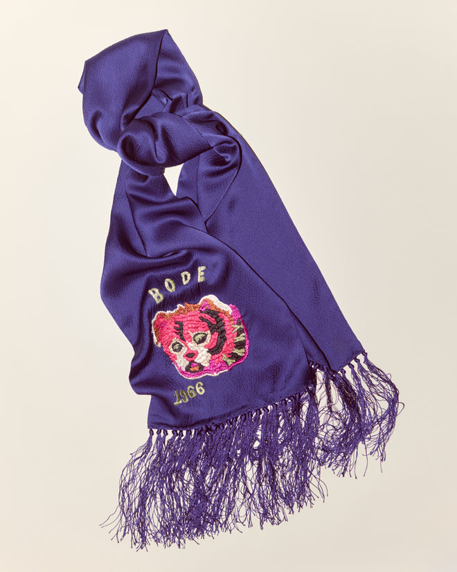 Dream Souvenir Scarf: Purple textured silk scarf with fringed ends, featuring pink and yellow dog face embroidery and "BODE 1966" text.