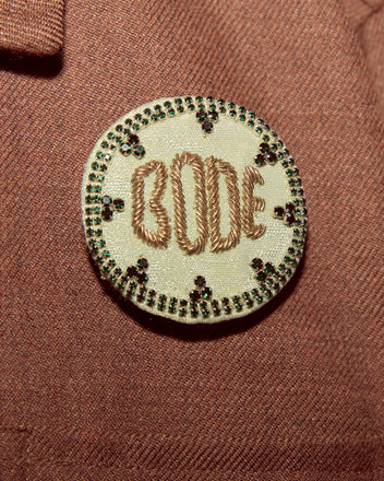 The Willow Brooch - Green features round embroidery with green details on brown satin, making it a unique and charming addition to your BODE accessories collection.
