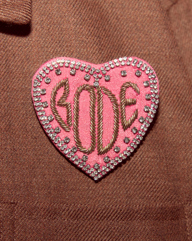 The Duchess Brooch is a pink heart-shaped accessory with 