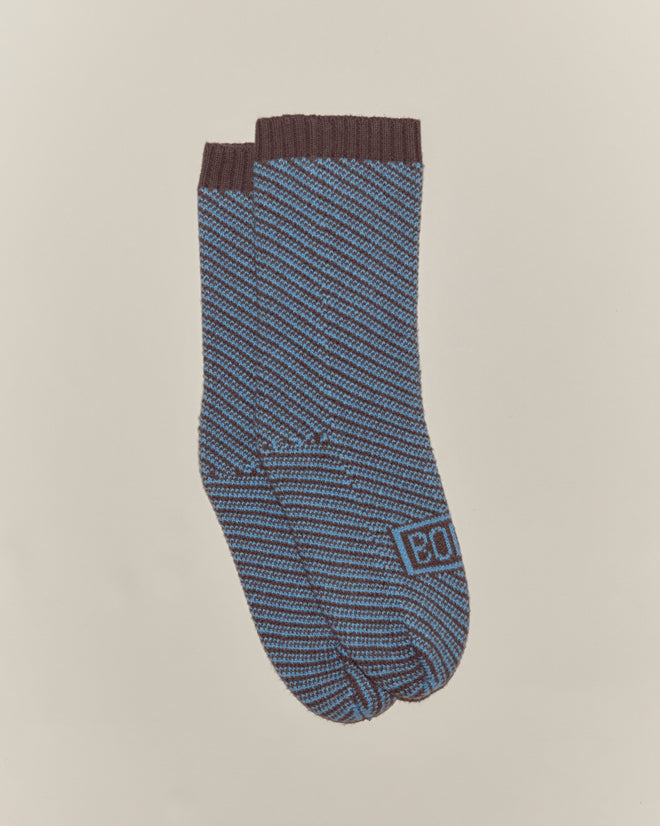 A pair of Duotone Jacquard Socks - Blue Grey, featuring blue and brown stripes, birdseye jacquard pattern, and 