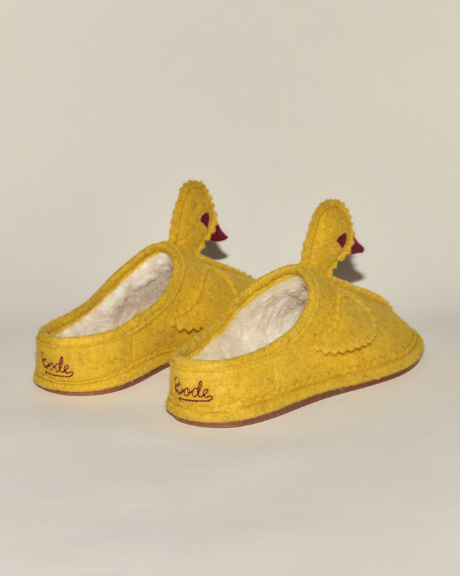 Add fun to your lounging with Duck Slipper - Yellow Red: cozy fleece-lined slippers in playful yellow, shaped like ducks and featuring 