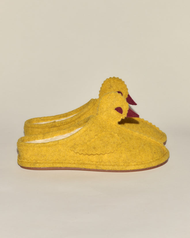 Duck Slipper - Yellow Red, shaped like ducks with wings and beaks, are displayed side by side on a plain background.