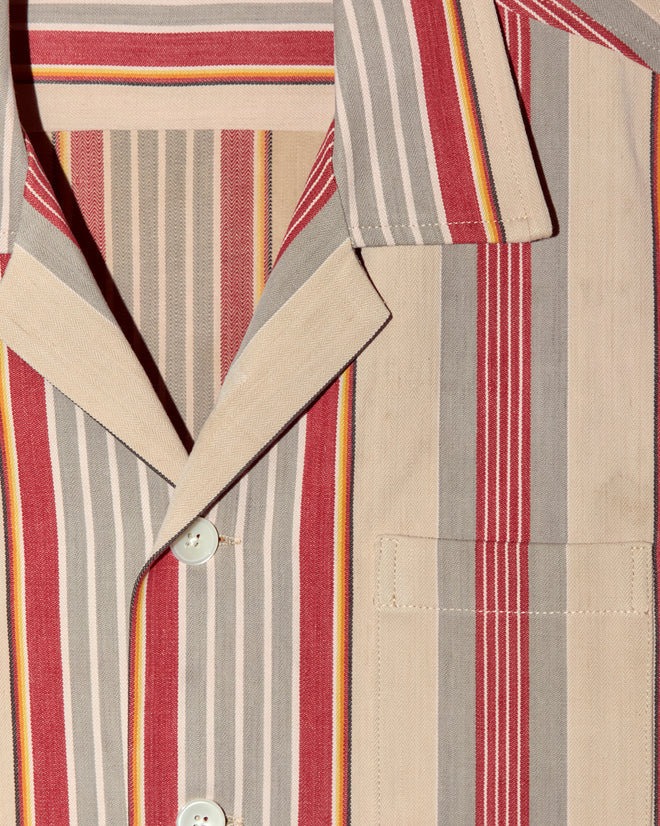 Close-up of the Fire Blanket Long Sleeve Shirt - M, featuring unique vertical red, gray, beige, and yellow stripes with white buttons, inspired by antique ticking jacket styles.