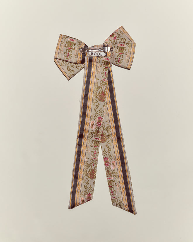 The Floret Brocade Bow Barrette features long tails, a "BODE" label, and classic French drapes bow styling, displayed on a plain background.