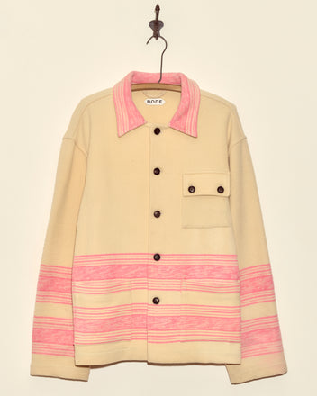 Unique Fuchsia Cream Jacket (M/L), a midcentury wool piece with pink stripes, brown buttons, and chest pocket, made in New York; shown hanging on a hook against a plain wall.