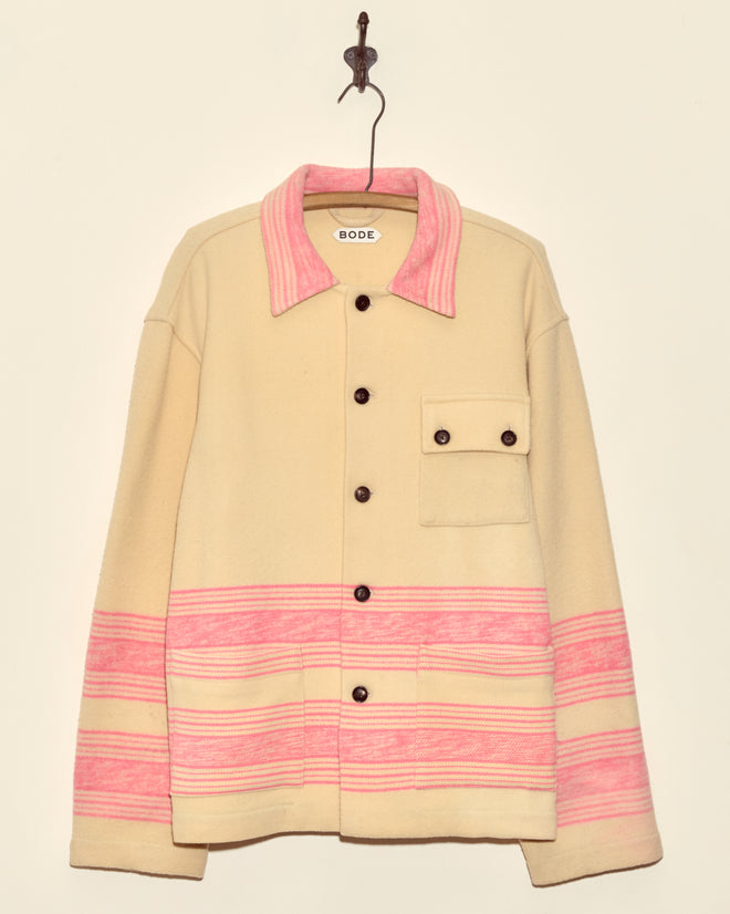 Unique Fuchsia Cream Jacket (M/L), a midcentury wool piece with pink stripes, brown buttons, and chest pocket, made in New York; shown hanging on a hook against a plain wall.