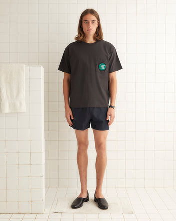 Washed cotton short sleeve tee with small tennis ball beaded on left breast pocket.