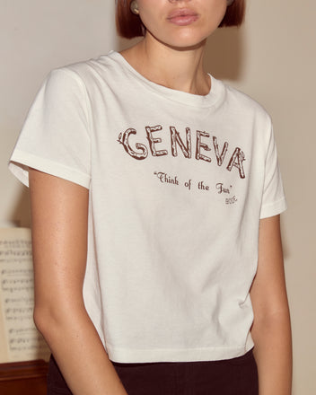 Someone wears a white Geneva Tee featuring 