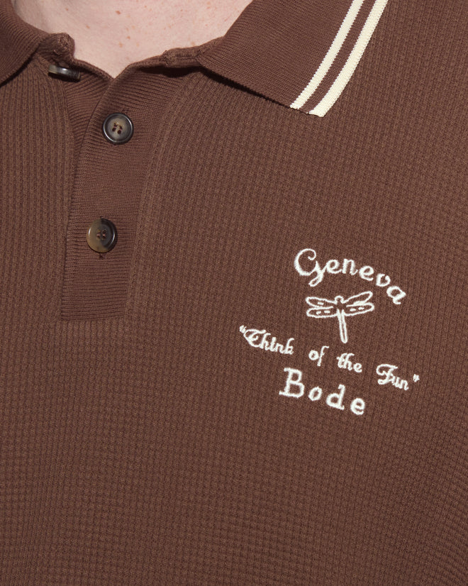 Close-up of the Geneva Waffle Polo, a brown heavyweight waffle pullover with buttons and white embroidered "Geneva 'Think of the Fun' Bode," inspired by Camp Geneva style.