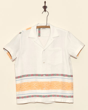 Geography Stripe Short Sleeve Shirt - XS: Handmade white button-up with orange and pink patterned stripes, displayed hanging on a hook.