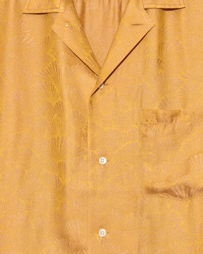 Close-up of the Golden Shell Short Sleeve Shirt - S, a unique yellow patterned jacquard button-up with chest pocket and collar, made in New York.
