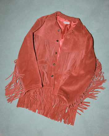 The Appalachian Jacket - Red features hand-cut suede fringe and buttons, shown laid flat on a light green background—a stylish nod to Western costume design.