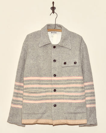 Gum Tree Stripe Jacket (XS) with pink and white horizontal stripes, crafted from wool in New York, hangs on a hook.