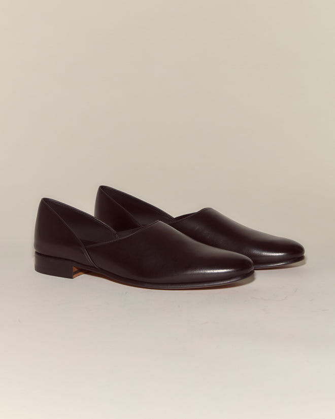 A pair of Leather House Shoes - Black, made from Napa leather with low heels, crafted in Italy, are displayed on a plain light background.