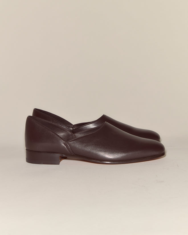 A pair of Leather House Shoes - Brown in dark Napa leather on a light background, combining Italian-inspired elegance with everyday comfort.