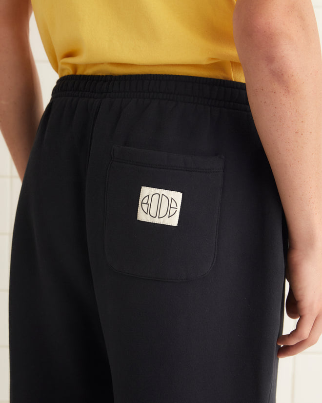 Black fleece cotton sweatpants with a Bode label on the back pocket.