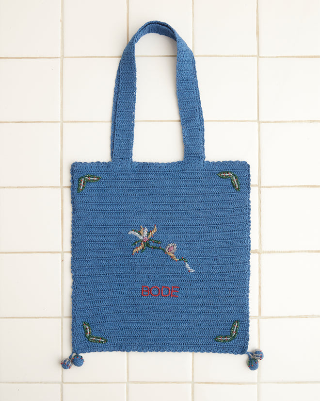 Laurel Crochet Tote in blue featuring an embroidered floral design with the word 