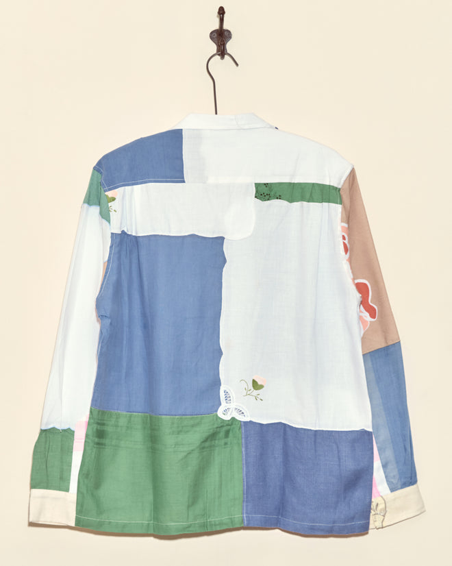 The Lavender Fields Napkin Shirt - M/L, a unique long-sleeve patchwork shirt in blue, white, green, and beige, is crafted from vintage fabrics and made in New York.