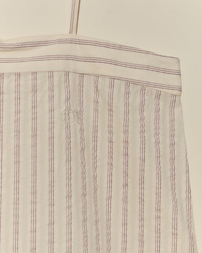The Lavender Sail Teddy is a white fabric bag crafted from antique shirting, featuring thin purple stripes and a small embroidered "R" on the front.