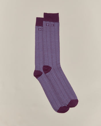 The Micro Check Socks - Purple are vintage children’s socks with a purple pattern, white stripes, and “BODE” text near the cuffs, made in Italy and shown laid flat on a neutral background.