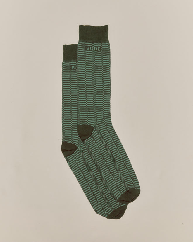 The Micro Check Socks - Green feature a green pattern with black accents and "BODE" text near the top, inspired by vintage 1960s children's socks and crafted in Italy.