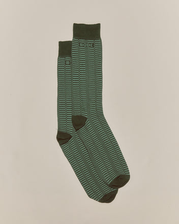The Micro Check Socks - Green feature a green pattern with black accents and 
