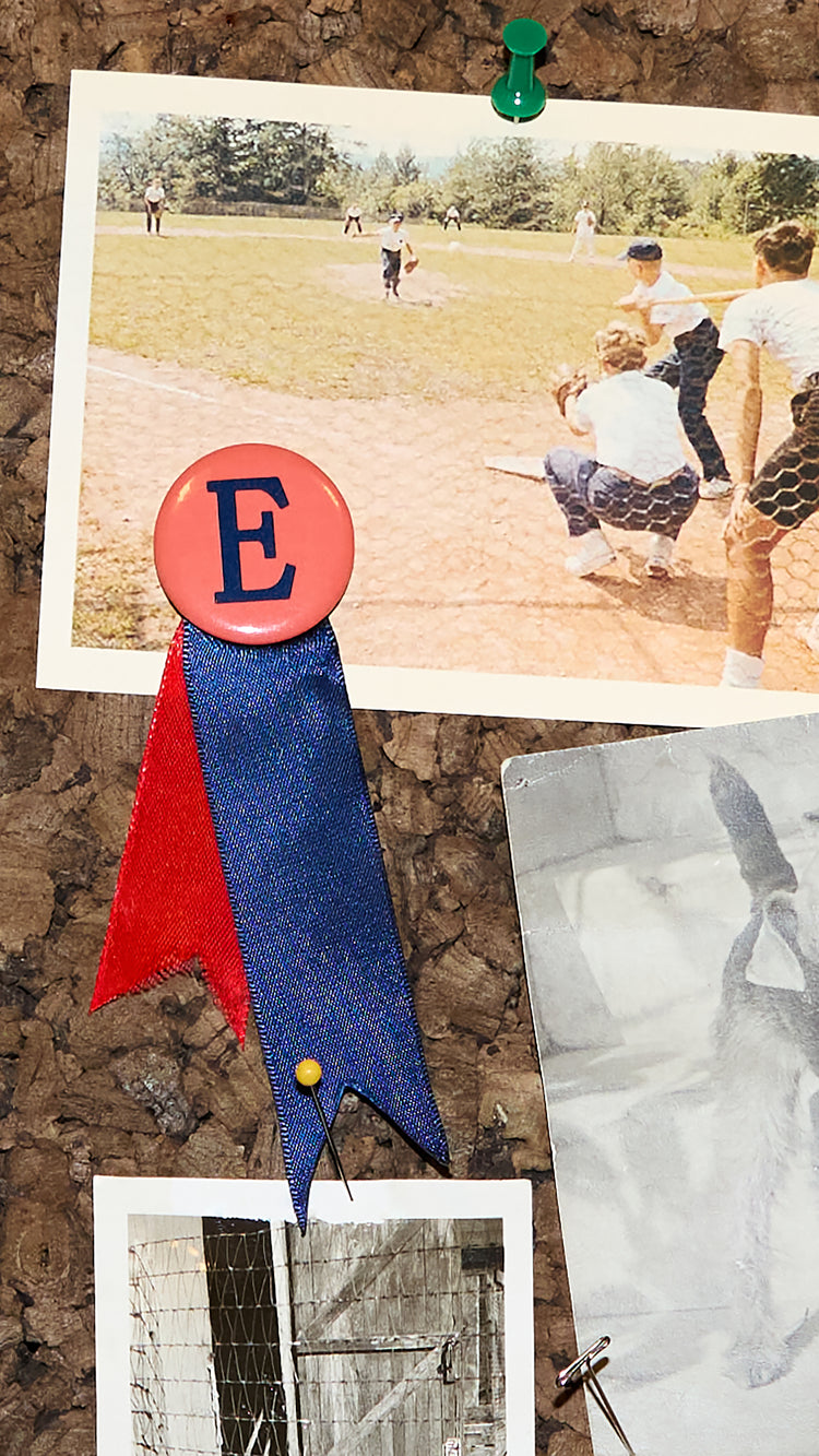 Detail of historical photographs on a cork bulletin board.