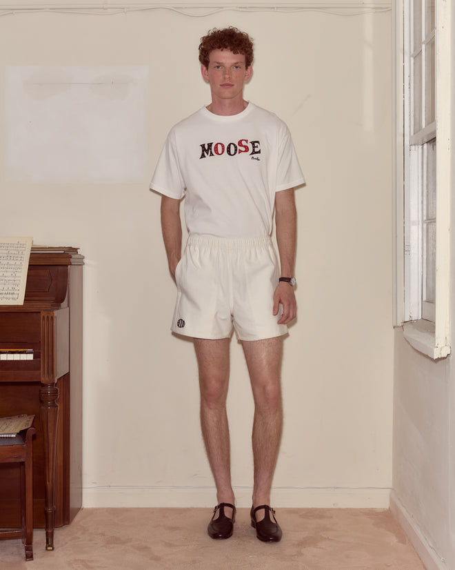 A young man in Field Shorts - White and a white 