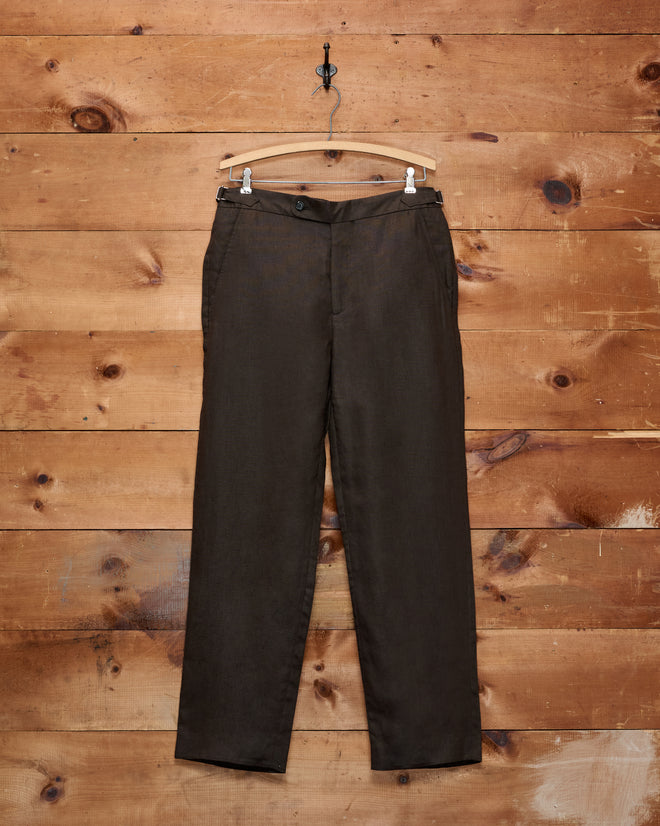 Lightweight Linen Side-Buckle Trousers in brown, displayed on a wooden hanger against a rustic wooden wall—these men’s summer trousers feature a stylish side-buckle design for a tailored fit.