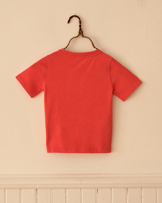 Back view of an orange Pumpkin Kids’ Tee, a vintage-style short-sleeved t-shirt on a hanger.