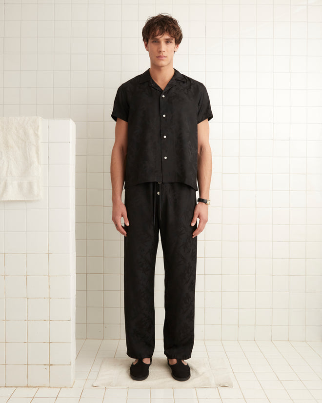 Black silk and viscose blend pajama pants with football player jacquard print with drawstring tie.