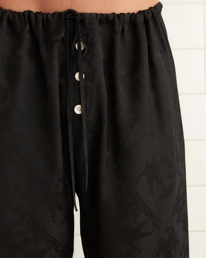 Black silk and viscose blend pajama pants with football player jacquard print with drawstring tie.