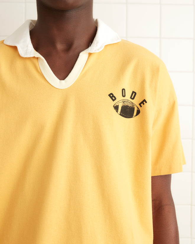 Gold cotton short sleeve polo with a black printed 