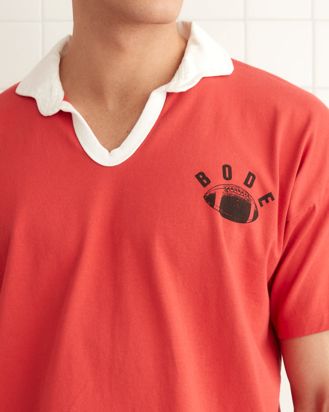 Red cotton short sleeve polo with a black printed 