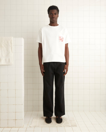 White cotton short sleeve tee with a red basketball embroidery on a left front pocket.