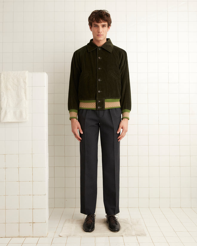 Dark green cotton collared jacket with creme and light green knit bands at the hem and cuffs.