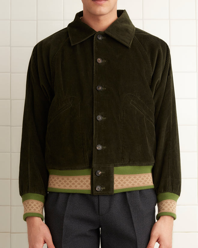 Dark green cotton collared jacket with creme and light green knit bands at the hem and cuffs.