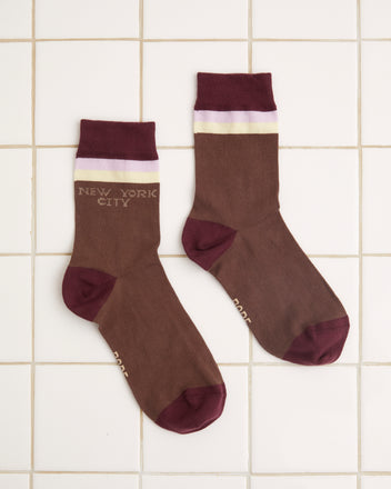 The Fairground Socks - Brown, featuring maroon toes and cuffs, the text 